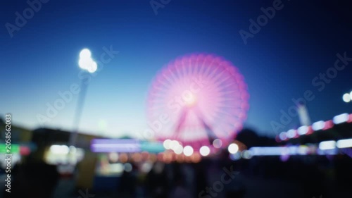 Blurred Carnival Lights With Colorful Bokeh At Amusement Park At Night