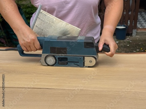 DIY Woodworker Smoothing Tabletop with Power Sander
