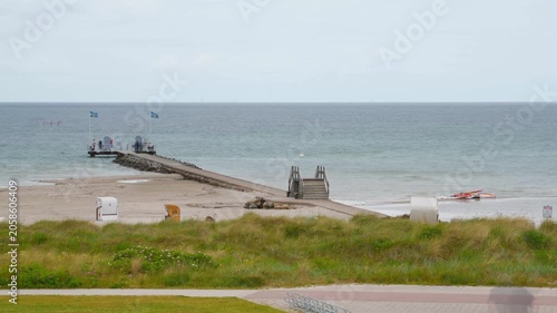 time-lapse of Baltic Sea beach life with long expusure motion blur of people, stone jetty in Stein near Laboe in Germany, Schleswig-Holstein, summer 2026