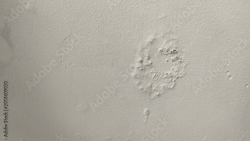 Close-up of a damaged interior wall with peeling paint and bubbles caused by water leakage. Concept for building maintenance, home renovation, moisture problems, and structural damp issues
