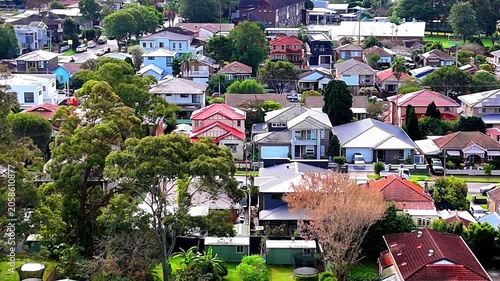 Drone panoramic aerial view of Sydney NSW Australia city Skyline and looking down on all suburban houses and streets of western Sydney of Burwood and Enfield