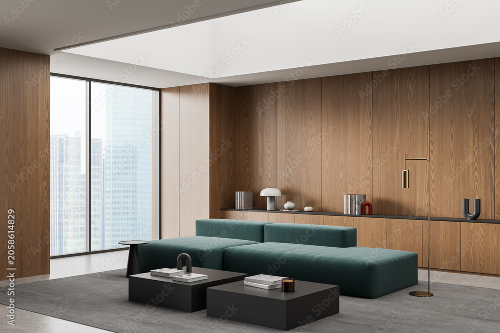 Fototapeta premium Modern interior lounge with teal modular sofa, wood‑panel walls, city‑view windows, sculptural decor and sleek furnishings arranged in spacious contemporary room. 3D Rendering