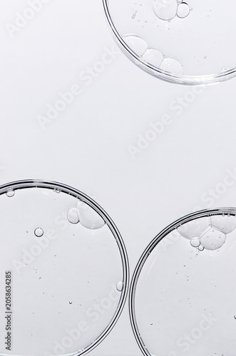 Liquid cosmetic product for the skin in a Petri dish. Copy space