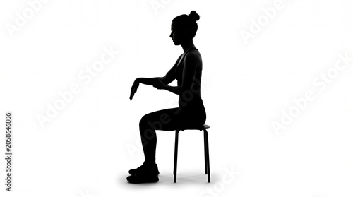 Woman in Silhouette Sitting on a Chair With One Arm Extended