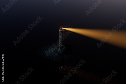 Fotografi Lighthouse sends light across dark ocean waters at night highlighting rocky shor