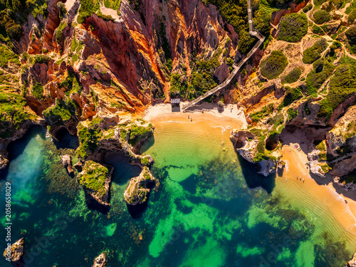 High angle Drone Point of View on the Rocky Coastline and famous Praia do Camilo Beach in Lagos, Algarve, Portugal, seen from directly above