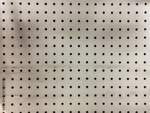 Принти на полотні Closeup of a white pegboard wall with evenly spaced holes