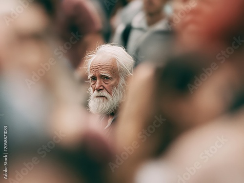 Senior man with white beard standing in blurred crowd, contemplative expression, urban setting