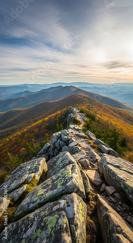 Rocky Mountain Ridge Overlooking Colorful Forest and Layered Peaks at Sunrise