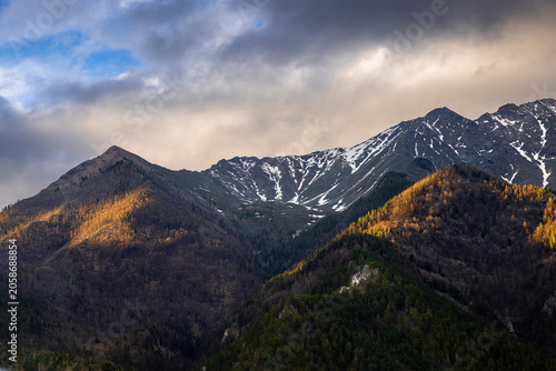 Sayan mountain range at the end of the day at sunset, snow-capped mountains in spring