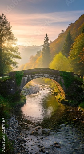 Mossy Stone Bridge Arching Over Forest River at Sunrise