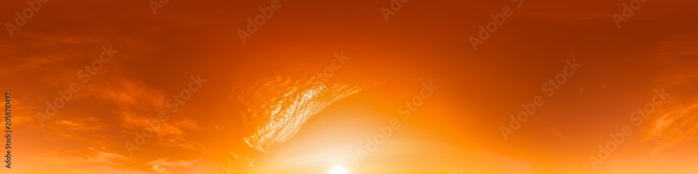 Obraz premium Sunset sky panorama showing vibrant orange clouds during golden hour with a bright sun on the horizon