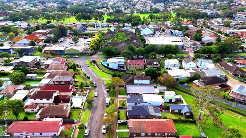 Drone panoramic aerial view of Sydney NSW Australia city Skyline and looking down on all suburban houses and streets of western Sydney of Burwood and Enfield