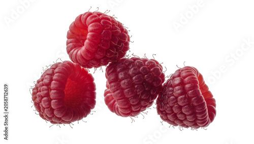 Billede på lærred Four ripe red raspberries clustered together, isolated on transparent background