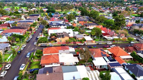 Drone panoramic aerial view of Sydney NSW Australia city Skyline and looking down on all suburban houses and streets of western Sydney of Burwood and Enfield