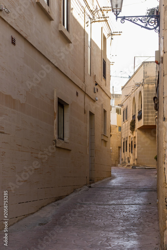 Quiet Narrow Stone Alleyway Between Historic Mediterranean Buildings With Warm Light