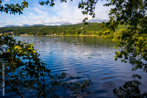 Photography Villas on the opposite shore of the Lago Grande di Avigliana with the still snow