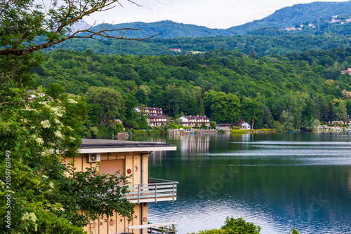 Villas on the shores of the Lago Grande di Avigliana surrounded by Alpine mountains at sunrise, Avigliana Nature Park, Susa Valley