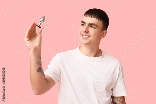 Smiling young man holding a...