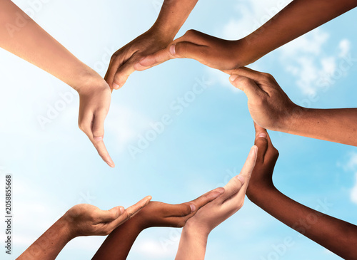 Collaboration And Inclusion as Business Unity and diversity partnership as hands joining in a group of diverse people connected together shaped as a support circle symbol of group team.