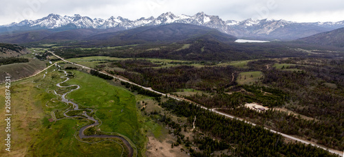 Sawtooth mountain with meandering river and highway cutting through forest