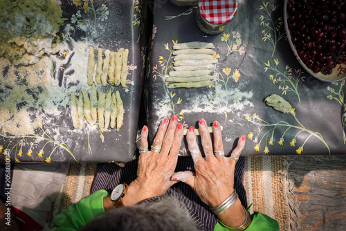 Elderly lady rolling pasta