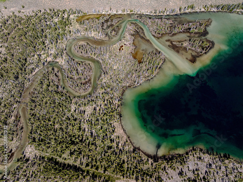 Aerial view of a wild meandering river and lake shore