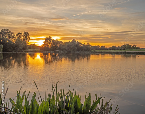 Beautiful late springtime sunset over water at Marston, Northwich, Cheshire, UK
