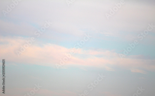 Fluffy white clouds in a bright blue sky. Clear atmosphere with cloud formations. Sky with selective focus. Blue sky with clouds.