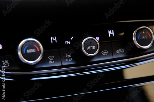 car's climate control button and temperature gauge
