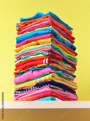 Stack of  neatly folded, multicoloured clothing 