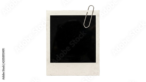 Obraz na płótnie Instant photograph with silver paper clip attached white frame and dark reflecti