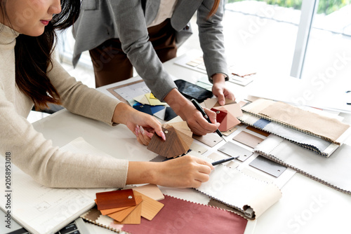 Professional Interior Designer Women Present Material Samples During Client Consultation Meeting