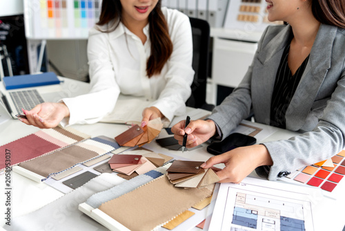Professional Interior Designers Present Material Samples During Client Consultation Meeting