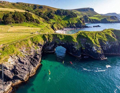 Coastal arch with kayaks in sea