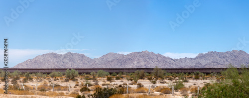 Obraz na płótnie Panoramic view of the US-Mexico border wall in the Sonoran Desert, Sonora, Mexico