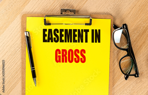 фотографія Easement in gross concept with clipboard, pen and eyeglasses on wooden desk, rep