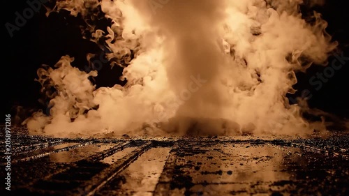 Dramatic White Smoke Billowing and Erupting from Wet Textured Ground with Warm Backlight, Low Angle Static Shot
