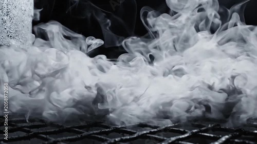 Thick White Smoke Billowing and Flowing Over Metal Grate Isolated on Black Background, Close-up Slow Motion