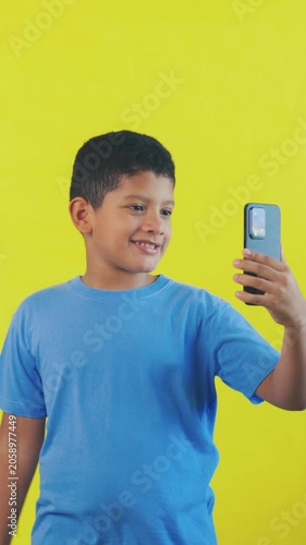 Happy little boy waving during a video call on a smartphone