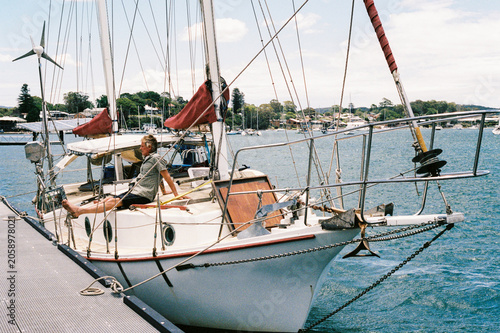 Vintage sailing boat docked at scenic harbor