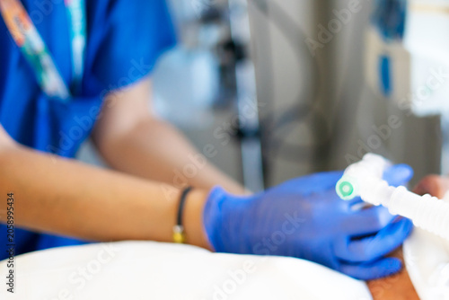 Nurse applying medical equipment to hospital patient
