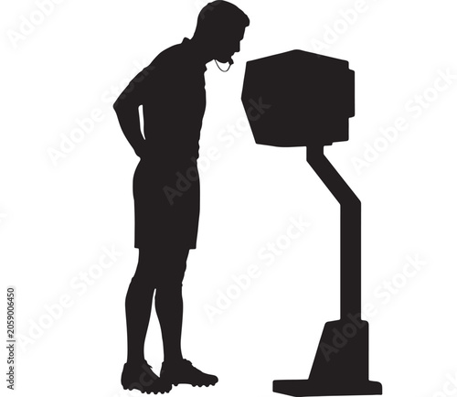 Coach stands before a tactical monitor to analyze gameplay statistics and player performance data.