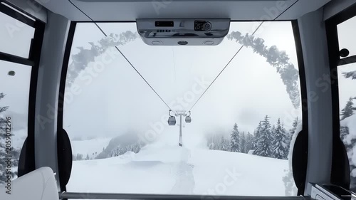 Modern cable car cabin moving through foggy winter snowstorm