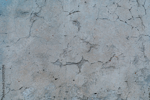 Pastel colored cracked grunge concrete wall texture.