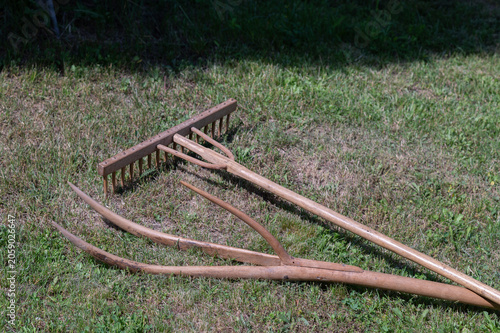 old wooden rake on field 