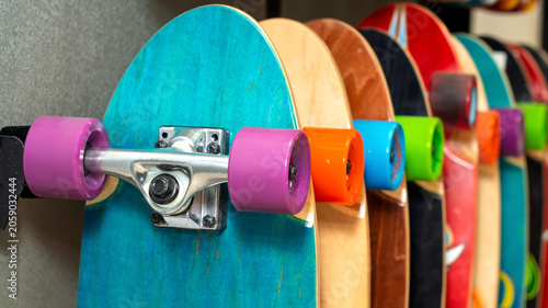 Bright skateboards with colorful wheels arranged on display in a shop, showcasing sports equipment and urban lifestyle products.
