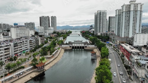 Modern Cityscape with River Canal, Bridges, and High-Rise Buildings