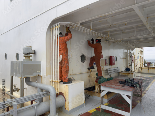 Vászonkép team of able seaman make descaling of ship accommodation.