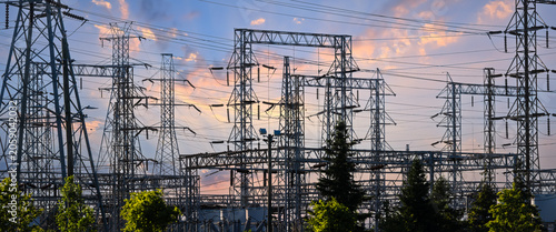 Power substation distributing electricity at sunset with transmission lines